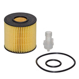 An automotive oil filter kit on a white background, including a pleated yellow filter with a black top, a small translucent plastic fitting, and two black O-rings.
