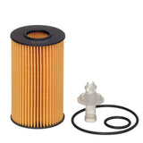 A cylindrical automotive oil filter with a pleated orange filter media and black end caps, shown alongside a clear plastic connector, black O-ring, and black rubber gasket on a plain white background.