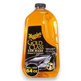 Meguiar's Gold Class Car Wash shampoo and conditioner in a 64 oz plastic bottle, showing the orange liquid inside against a white background.