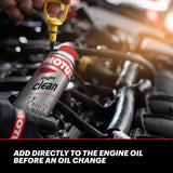 MOTUL engine cleaner can being added to a car engine with text 'Add directly to the engine oil before an oil change'.