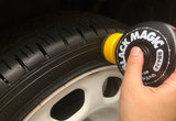 Autohub Pakistan Soft99 Black Magic tire coating being applied to a car tire sidewall with an integrated sponge