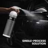 Person using a spray bottle labeled 'QS' on a car's mirror with the text 'Single-Process Solution'.